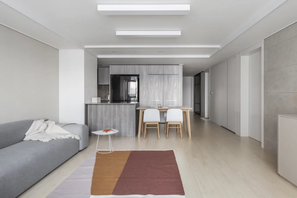 Appartement spacieux avec salon gris, cuisine ouverte et salle à manger, optimisé par un architecte à La Madeleine