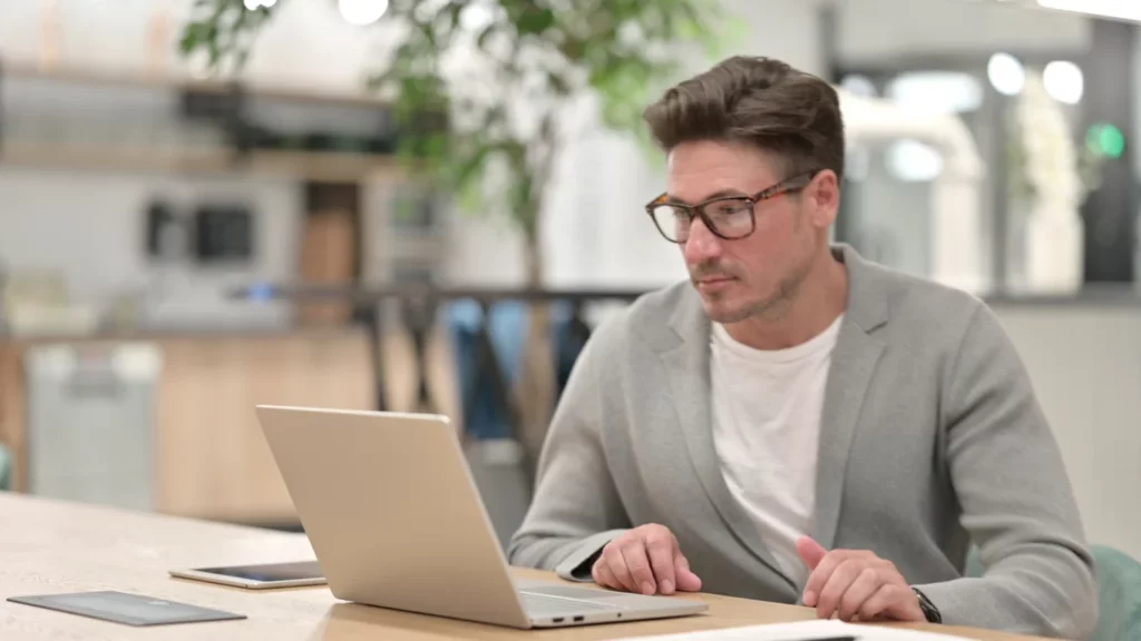 Un homme qui apprends l'utilisation d'un logiciel de décoration d'intérieur gratuit