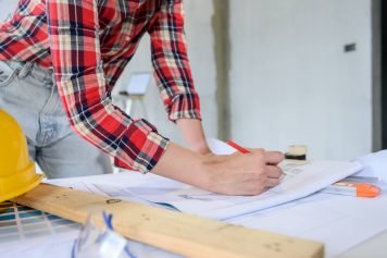 L'ingénieur d'une entreprise rénovation intérieur maison se concentre sur la modification des plans.